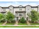 Charming townhouse with well-kept landscaping, gray trim, covered entry, and quaint balcony at 7724 Sweet Star Ave, Orlando, FL 32836