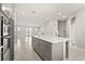 Open floorplan kitchen with island overlooking the living space with stainless appliances and tile flooring at 7724 Sweet Star Ave, Orlando, FL 32836