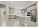 Bright kitchen features stainless steel appliances, white cabinetry, and a large center island at 7724 Sweet Star Ave, Orlando, FL 32836