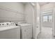 Laundry room with a washer, dryer, and wire shelving at 7724 Sweet Star Ave, Orlando, FL 32836