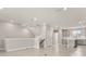 Open-concept living space with tile flooring, featuring a view of the staircase and kitchen at 7724 Sweet Star Ave, Orlando, FL 32836