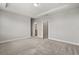 A bright main bedroom boasts plush carpeting and an ensuite bathroom at 7724 Sweet Star Ave, Orlando, FL 32836