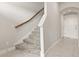 Carpeted staircase with wooden handrail and white trim, leading upstairs from the tiled entryway at 7724 Sweet Star Ave, Orlando, FL 32836