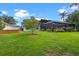 View of the lush lawn with small tree and flower boxes, along with the pool enclosure at 824 Spring Island Way, Orlando, FL 32828