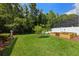 Lush backyard featuring well-maintained lawn, garden beds, and mature trees for a serene outdoor space at 824 Spring Island Way, Orlando, FL 32828