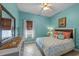 Coastal-themed bedroom with blue walls, a dresser adorned with sea-inspired decor and a starfish pillow at 824 Spring Island Way, Orlando, FL 32828