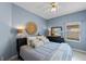 Cozy bedroom with a ceiling fan, a decorative wall hanging, and a comfortable bed at 824 Spring Island Way, Orlando, FL 32828