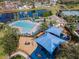 Aerial view of community pool, playground, and recreational facilities with water views at 824 Spring Island Way, Orlando, FL 32828