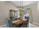 Traditional dining room with wooden table set, stylish chandelier, and elegant display cabinet at 824 Spring Island Way, Orlando, FL 32828