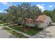 A well maintained home with manicured landscaping and a large tree, located on a quiet street at 824 Spring Island Way, Orlando, FL 32828