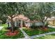 Inviting home featuring manicured lawn, mature trees, and a welcoming front entrance at 824 Spring Island Way, Orlando, FL 32828