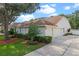 Well-maintained home with a three-car garage, lush landscaping, and a manicured lawn at 824 Spring Island Way, Orlando, FL 32828