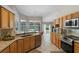 Well-lit kitchen with stainless steel appliances, granite countertops, and a view of the outdoor pool area at 824 Spring Island Way, Orlando, FL 32828