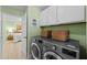 Convenient laundry room equipped with modern machines and ample storage space at 824 Spring Island Way, Orlando, FL 32828