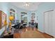Inviting home office with abundant natural light, wood floors, and spacious work areas at 824 Spring Island Way, Orlando, FL 32828
