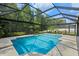 This screened-in pool has tiled edging and is surrounded by lush plants at 824 Spring Island Way, Orlando, FL 32828