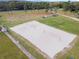Aerial view of a volleyball court in a community surrounded by parking and green space at 824 Spring Island Way, Orlando, FL 32828