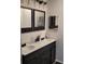 Elegant bathroom featuring a double sink vanity with dark wood cabinets and stylish mirrors at 8539 Clematis Ln, Orlando, FL 32819