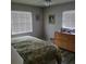 Comfortable bedroom featuring a large bed, wooden dresser, and natural lighting at 8539 Clematis Ln, Orlando, FL 32819