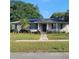Charming single-story home with well-maintained lawn, garden, and solar panels at 8539 Clematis Ln, Orlando, FL 32819