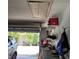 Well-organized garage with open door, storage shelves, and tools at 8539 Clematis Ln, Orlando, FL 32819