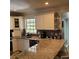 Spacious kitchen featuring granite countertops, white cabinets, and stainless steel sink at 8539 Clematis Ln, Orlando, FL 32819