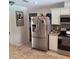 The kitchen featuring a stainless steel refrigerator and granite countertop, a modern and functional space at 8539 Clematis Ln, Orlando, FL 32819