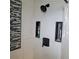 Modern shower featuring white tile, mosaic accents, niche shelving and black shower head at 8539 Clematis Ln, Orlando, FL 32819