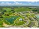 Aerial view of community featuring homes, ponds, pool, playground, and lush green spaces at 868 Brooklet Dr, Davenport, FL 33837