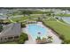 Aerial view of the community pool, playground, grassy areas and surrounding homes in a desirable neighborhood at 868 Brooklet Dr, Davenport, FL 33837