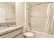 Bathroom with granite counters, shower/tub combo with white tiling and white fixtures at 868 Brooklet Dr, Davenport, FL 33837