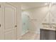 Modern bathroom featuring granite countertops, dual sinks, and sleek glass-enclosed shower at 868 Brooklet Dr, Davenport, FL 33837