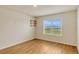 Bedroom with hardwood flooring and a large window overlooking the backyard at 868 Brooklet Dr, Davenport, FL 33837
