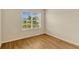 Well-lit bedroom featuring hardwood floors and large windows at 868 Brooklet Dr, Davenport, FL 33837