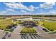 Aerial view of community center with a playground, lake, and pavilion, showcasing recreational amenities at 868 Brooklet Dr, Davenport, FL 33837