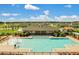 Beautiful community pool area with a splash fountain, covered seating, lounge chairs, and well-maintained landscaping at 868 Brooklet Dr, Davenport, FL 33837