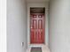 Close-up of a classic red front door with detailed panels and a secure lock at 868 Brooklet Dr, Davenport, FL 33837