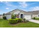 Charming home showcasing lush landscaping, a two-car garage and a well-maintained lawn at 868 Brooklet Dr, Davenport, FL 33837