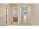 A bright hallway with tile flooring leads to rooms with wood and tile flooring at 868 Brooklet Dr, Davenport, FL 33837