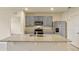 Kitchen with granite countertops, stainless steel appliances and gray cabinets at 868 Brooklet Dr, Davenport, FL 33837