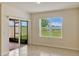 Bright living room boasts sliding glass doors and a window overlooking the backyard at 868 Brooklet Dr, Davenport, FL 33837