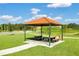 Beautiful picnic area with shelter and tables on a sunny day with green grass at 868 Brooklet Dr, Davenport, FL 33837
