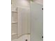 Modern glass shower features built-in shelving and curved interior tiling at 868 Brooklet Dr, Davenport, FL 33837