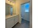 Bathroom with a single sink vanity, tile floor, and a toilet in a separate room at 931 Azalea Walk Cir, Deland, FL 32724