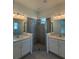 Spacious primary bathroom featuring dual sinks, tile floors, and glass shower at 931 Azalea Walk Cir, Deland, FL 32724