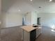 Bright, airy kitchen featuring a center island with a sink, ample cabinet space, and a breakfast bar at 931 Azalea Walk Cir, Deland, FL 32724