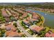Aerial view of planned lakeside community with pools, parks, and well-kept landscaping at 10829 Royal Cypress Way, Orlando, FL 32836