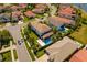 Aerial view of a home with a pool, landscaping, and outdoor living area at 10829 Royal Cypress Way, Orlando, FL 32836