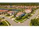 Aerial view of a beautiful home surrounded by lush landscaping near a lake at 10829 Royal Cypress Way, Orlando, FL 32836