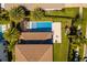 Aerial view of backyard featuring pool, lush lawn, and play set at 10829 Royal Cypress Way, Orlando, FL 32836